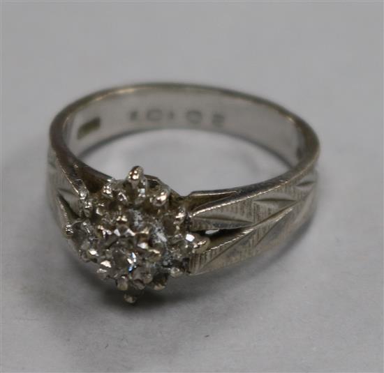 An 18ct white gold and diamond cluster ring, size O.